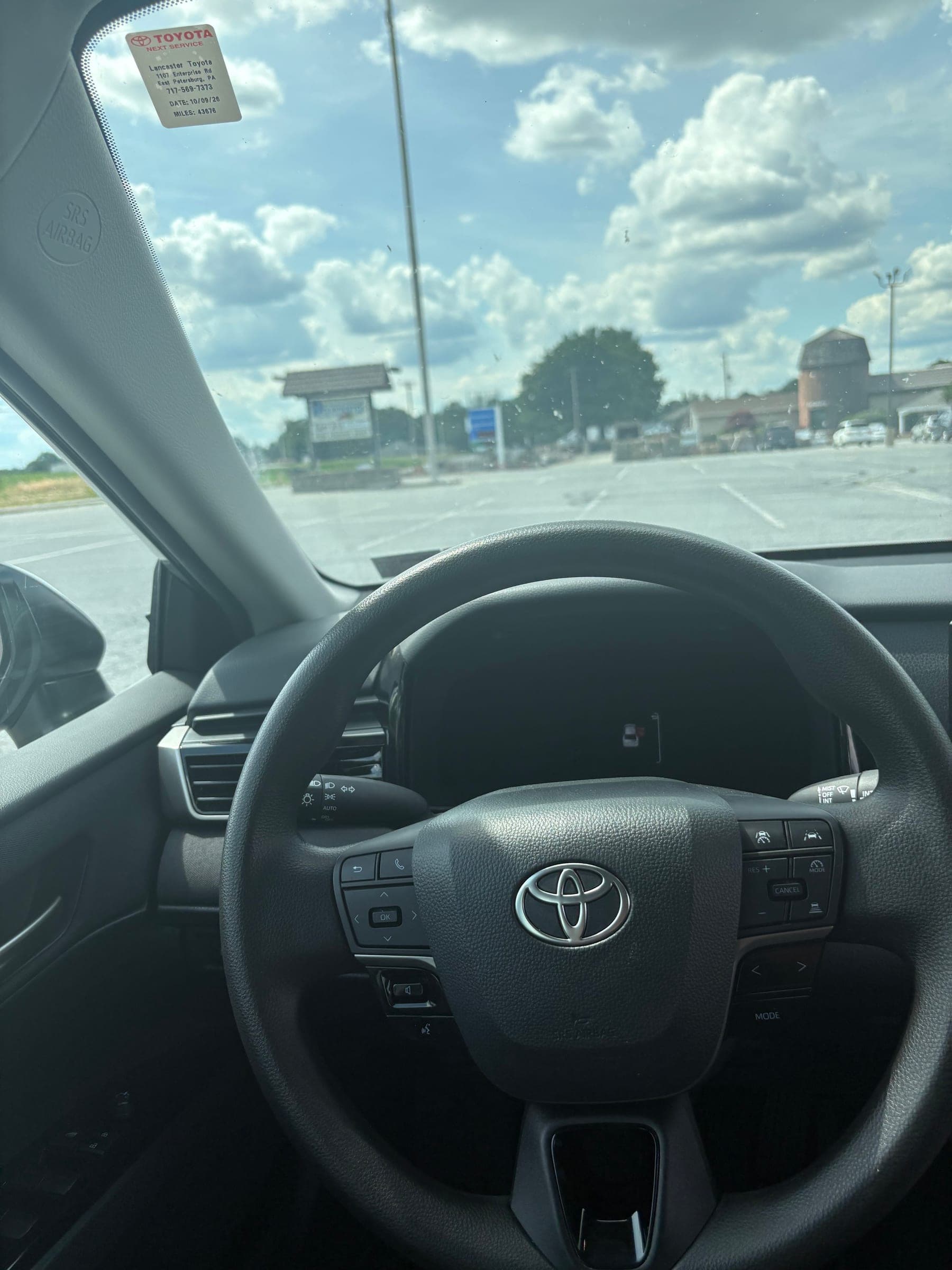 Detail closeup of the cleaned Toyota steering wheel with a spotless center hub and controls