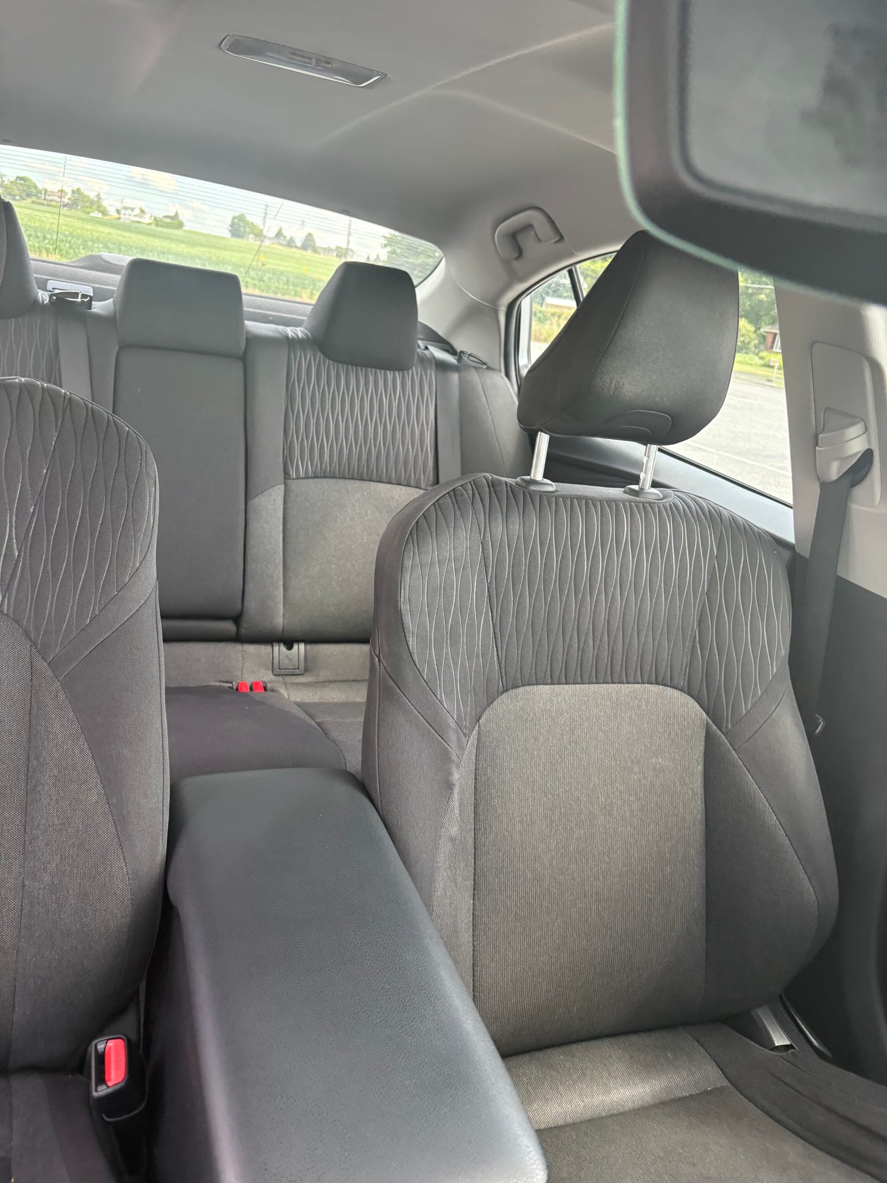 Interior cabin view looking forward at both front seatbacks, headliner, and sunroof frame after detailing